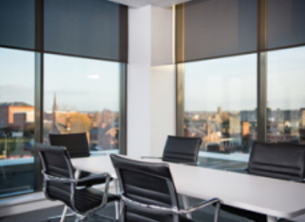 An interior shot of a Base meeting room showing a table and chairs